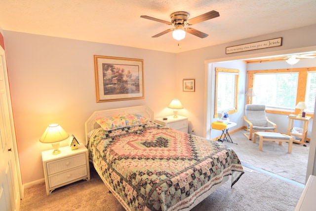 carpeted bedroom featuring a closet and ceiling fan