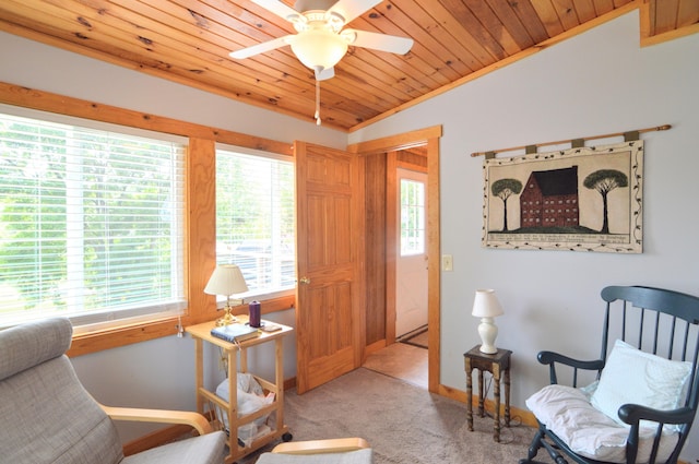 living area with ceiling fan, lofted ceiling, light carpet, and wooden ceiling