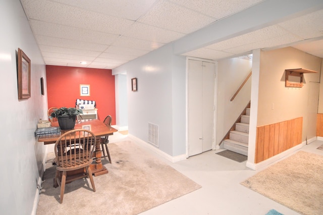 interior space with a drop ceiling and concrete floors