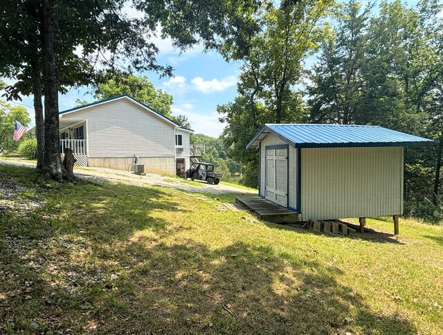 view of yard with a storage shed and central air condition unit