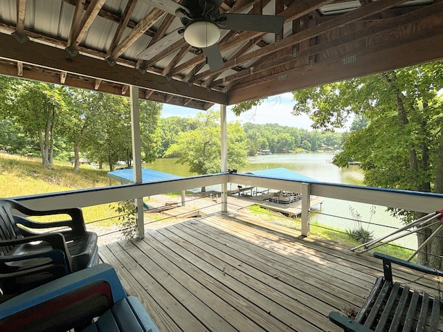 wooden deck with a water view and ceiling fan