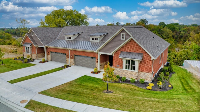 craftsman house with a garage, central AC, and a front lawn