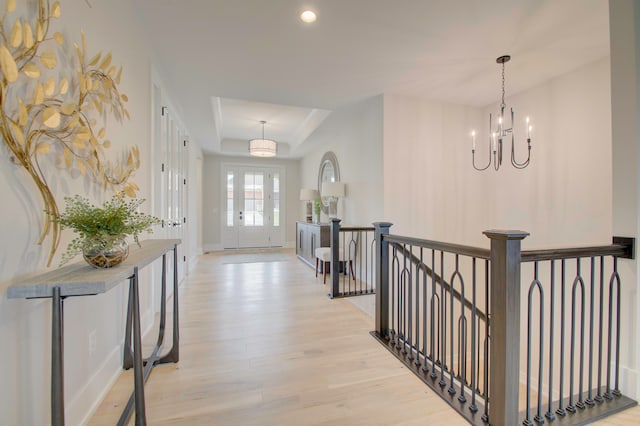 entryway featuring an inviting chandelier and light hardwood / wood-style flooring