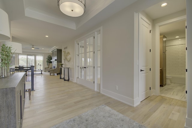 828 Fairbanks Ln, Southgate, KY 41071 - hallway with french doors, light wood-style flooring, recessed lighting, and a raised ceiling