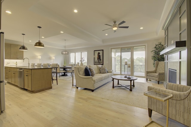 828 Fairbanks Ln, Southgate, KY 41071 - living area featuring light wood finished floors, a wealth of natural light, ceiling fan, and a raised ceiling