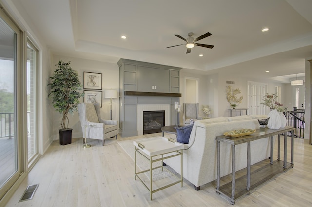 828 Fairbanks Ln, Southgate, KY 41071 - living room with a glass covered fireplace, visible vents, light wood-type flooring, and a raised ceiling