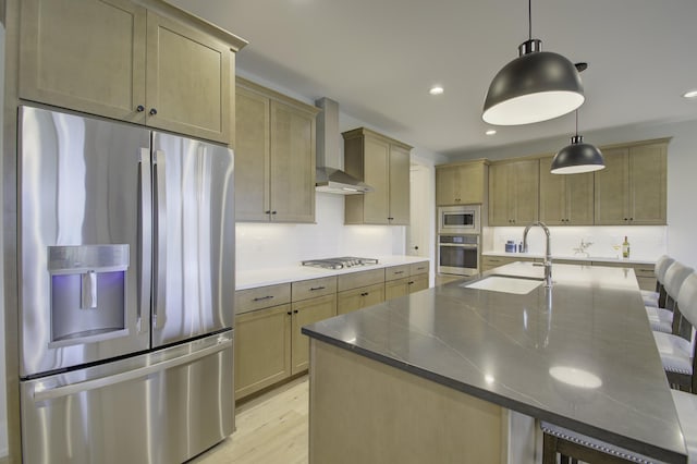 828 Fairbanks Ln, Southgate, KY 41071 - kitchen with a kitchen bar, wall chimney exhaust hood, appliances with stainless steel finishes, a sink, and light wood-style floors