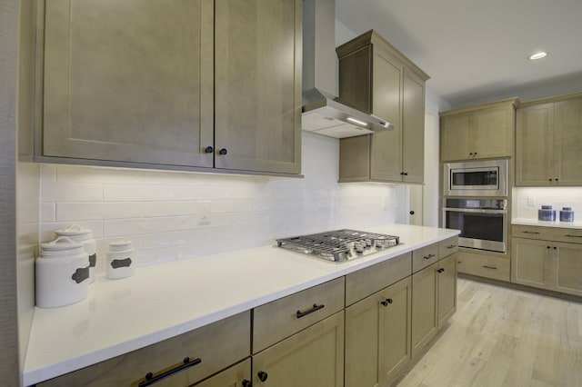 828 Fairbanks Ln, Southgate, KY 41071 - kitchen with wall chimney range hood, light wood-style flooring, decorative backsplash, and stainless steel appliances