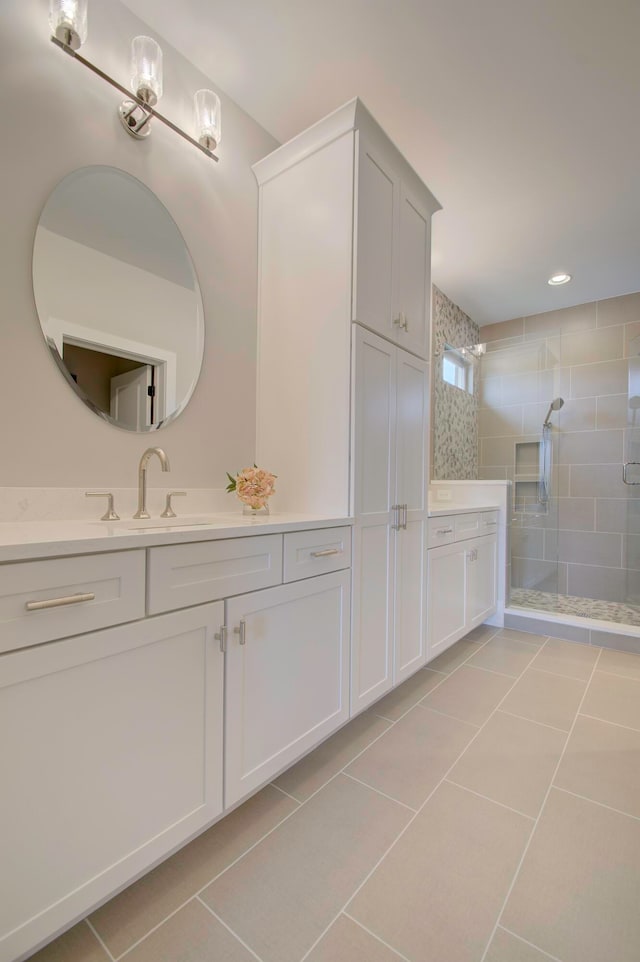 bathroom with vanity, tile patterned flooring, and a shower with shower door