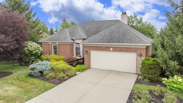 view of front facade featuring a front yard and a garage