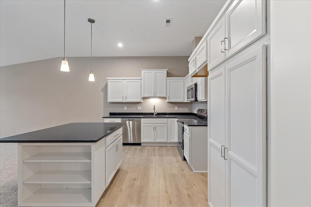 kitchen featuring white cabinetry, appliances with stainless steel finishes, a center island, and sink