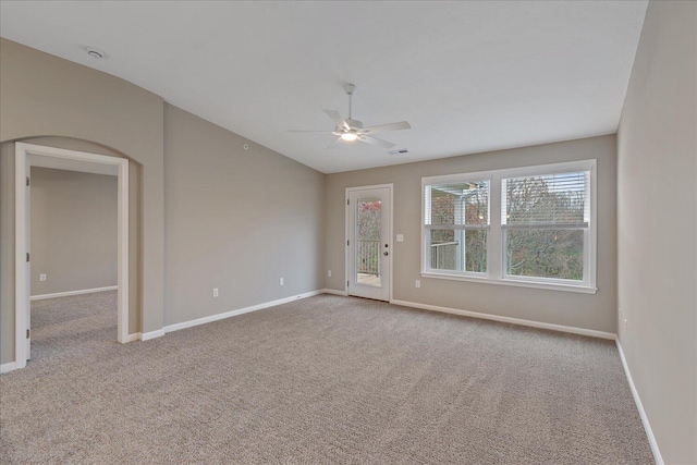 carpeted empty room with ceiling fan and vaulted ceiling