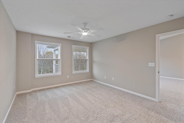 carpeted empty room featuring ceiling fan