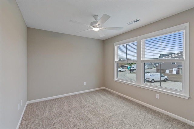 carpeted empty room featuring ceiling fan