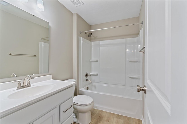 full bathroom featuring wood-type flooring, toilet, shower / bathing tub combination, and vanity