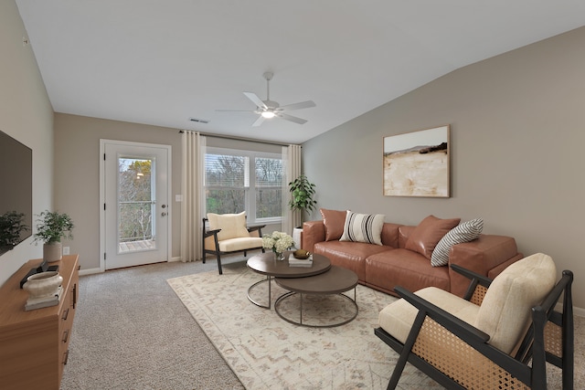 carpeted living room featuring ceiling fan and lofted ceiling