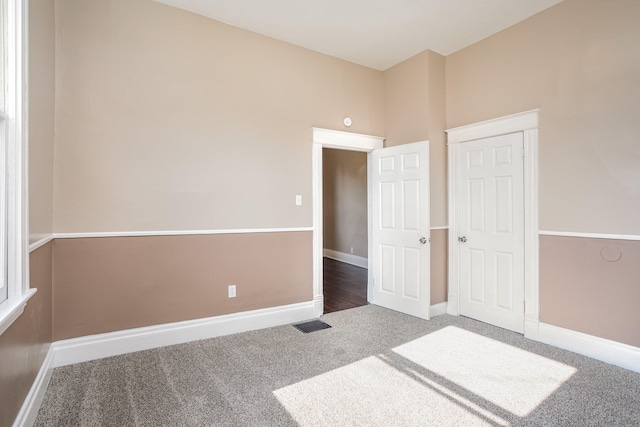 unfurnished bedroom with carpet floors