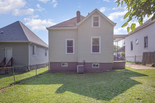 back of house featuring a lawn and central AC unit