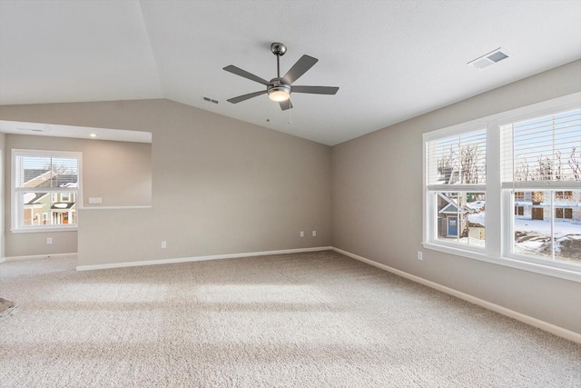 unfurnished room featuring lofted ceiling, carpet flooring, and ceiling fan