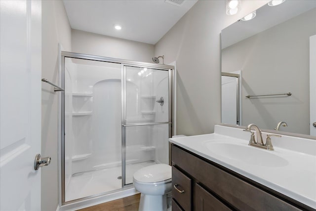 bathroom with vanity, hardwood / wood-style floors, toilet, and walk in shower