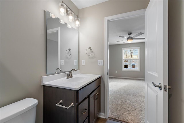 bathroom featuring vanity, ceiling fan, and toilet