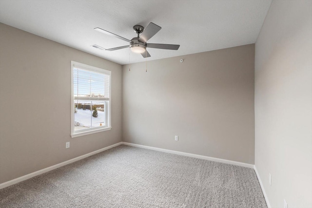 carpeted spare room featuring ceiling fan and a textured ceiling