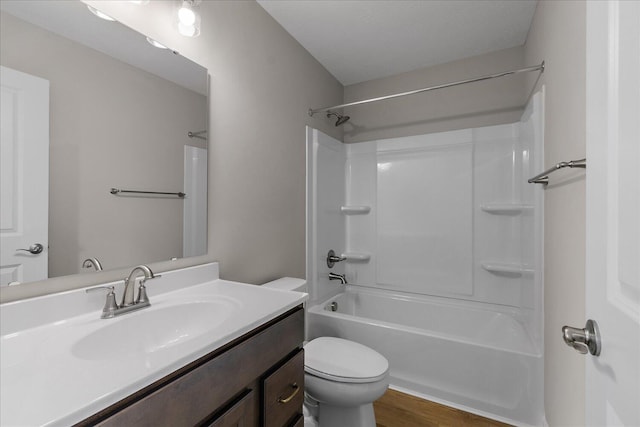 full bathroom with hardwood / wood-style flooring, vanity, toilet, and shower / bathing tub combination