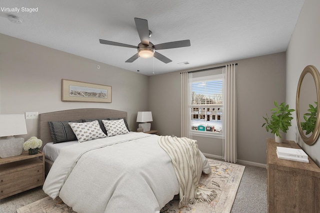 carpeted bedroom with a textured ceiling and ceiling fan