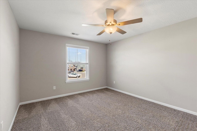 spare room featuring a textured ceiling, carpet floors, and ceiling fan