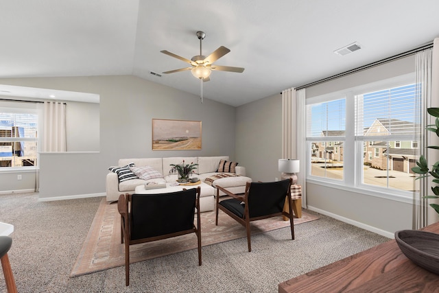 interior space with baseboards, visible vents, vaulted ceiling, and carpet flooring