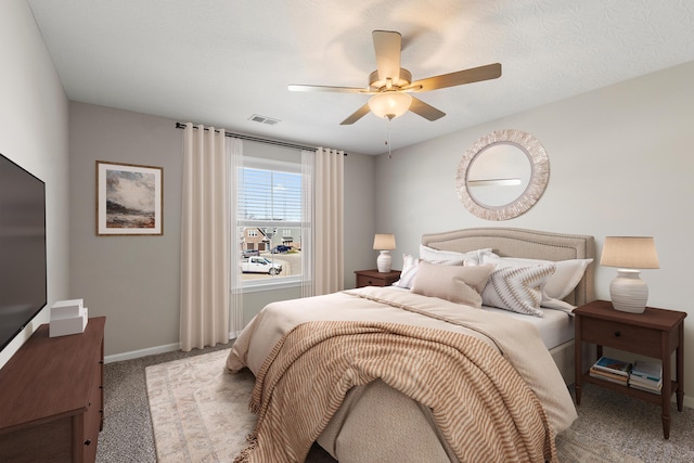 bedroom with carpet floors, visible vents, baseboards, and a ceiling fan