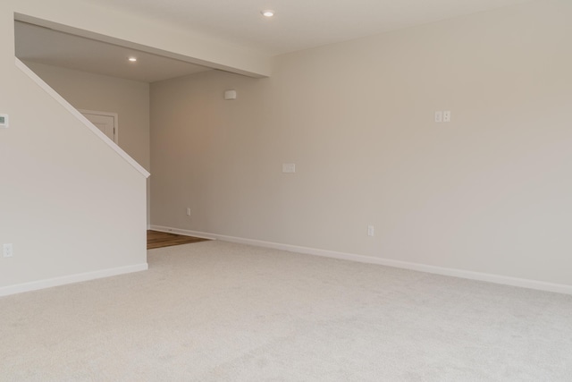 empty room with beamed ceiling and carpet floors