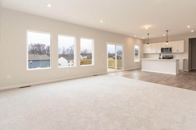 unfurnished living room with light hardwood / wood-style flooring