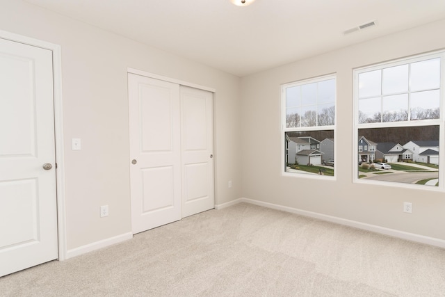 carpeted bedroom featuring a closet