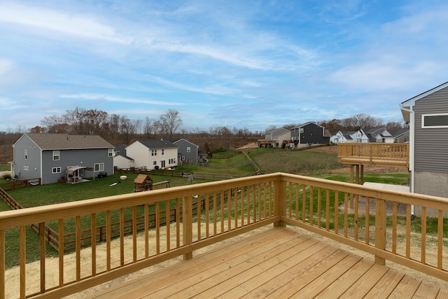 wooden deck featuring a lawn