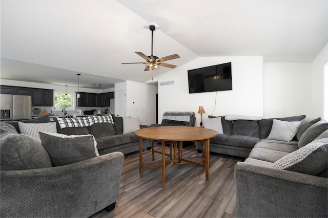 living room featuring ceiling fan, sink, lofted ceiling, and hardwood / wood-style flooring