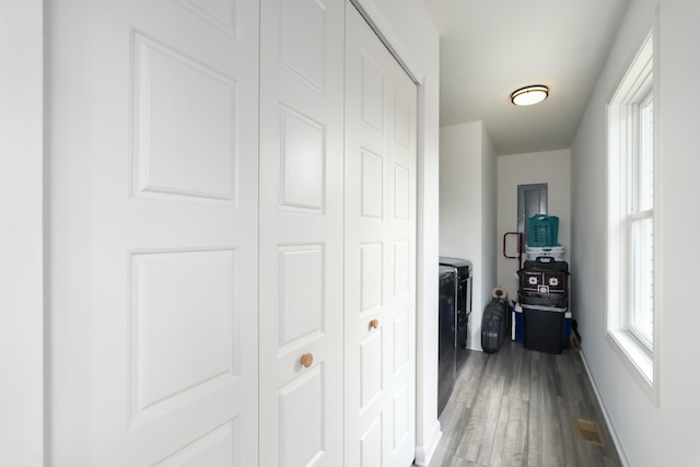 hallway with hardwood / wood-style floors