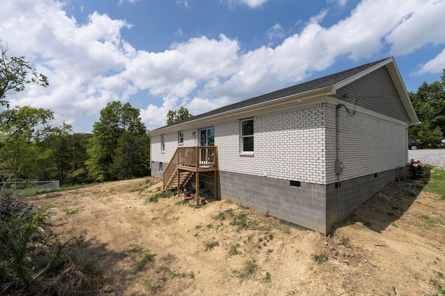 view of side of property featuring a wooden deck