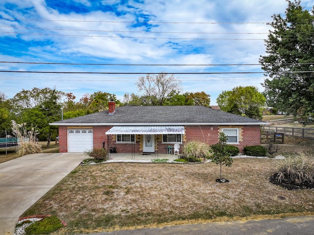 single story home featuring covered porch and a garage