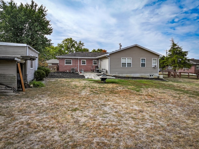 rear view of property featuring a lawn and a patio