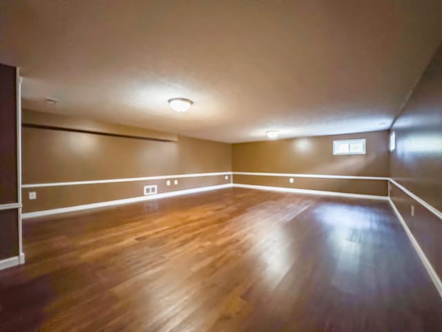 empty room with dark hardwood / wood-style floors