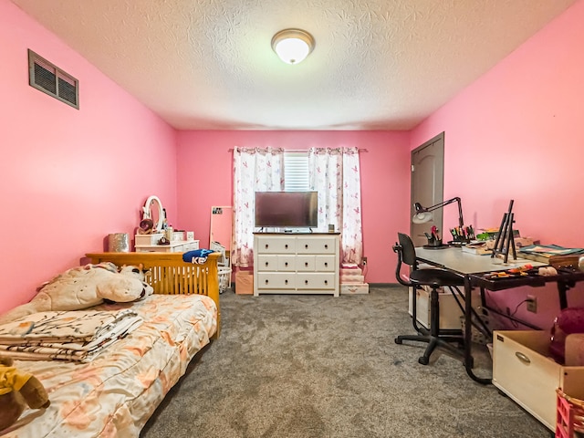 bedroom featuring a textured ceiling and dark colored carpet