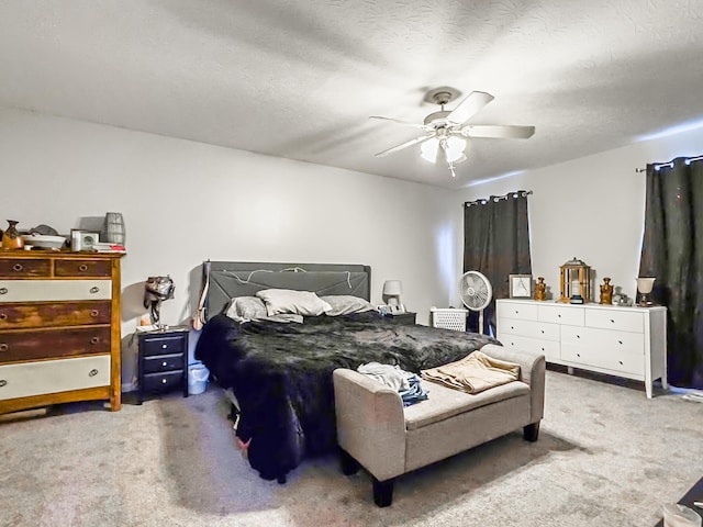 bedroom with ceiling fan, a textured ceiling, and carpet