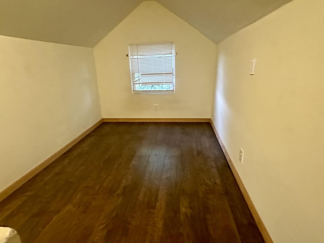 bonus room featuring dark wood-style floors, lofted ceiling, and baseboards