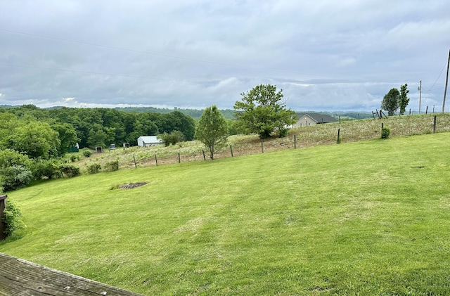 view of yard featuring a rural view and fence