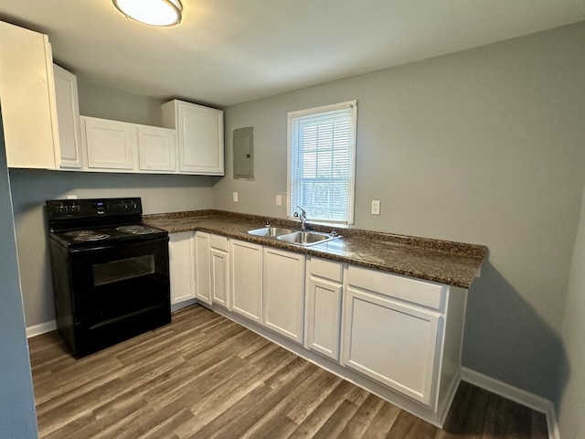 kitchen with white cabinetry, black / electric stove, a sink, and wood finished floors