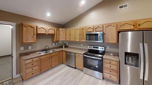304 Brentwood Dr, Dry Ridge, KY 41035 - kitchen with appliances with stainless steel finishes, a sink, vaulted ceiling, light brown cabinetry, and light wood-style flooring