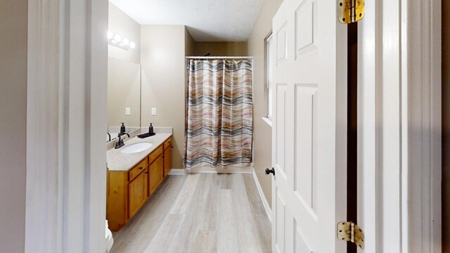 304 Brentwood Dr, Dry Ridge, KY 41035 - bathroom with vanity, wood finished floors, a shower with shower curtain, and baseboards