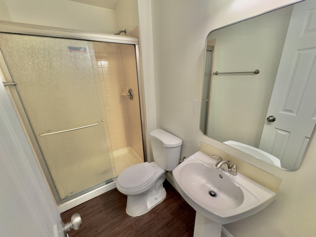 bathroom featuring toilet, an enclosed shower, wood-type flooring, and sink