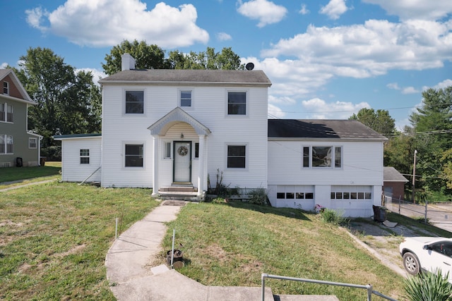 view of front facade featuring a front lawn and a garage